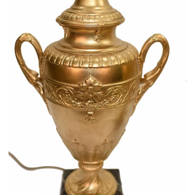 Gorgeous pair of French gilt table lamps In the form of classical amphora vase or urns. Dimensions in inches (CM): Width x...