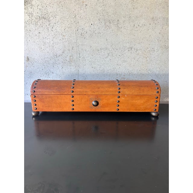 Vintage mid-century decorative box clad in warm cognac-toned leather with handsome bronze accents. Features rows of...