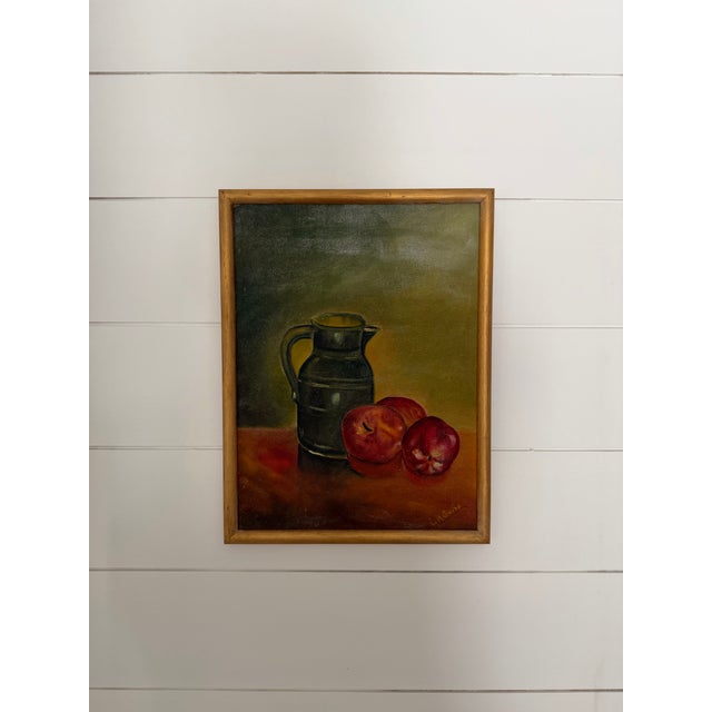 This is a vintage still life of a green pitcher with 3 apples. It is painted on board and custom framed in thin vintage...