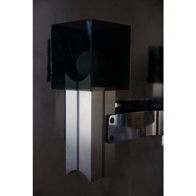 Designed by Gaetano Sciolari, this 1970's vintage Italian chandelier utilizes polished chromed steel in the light housing...