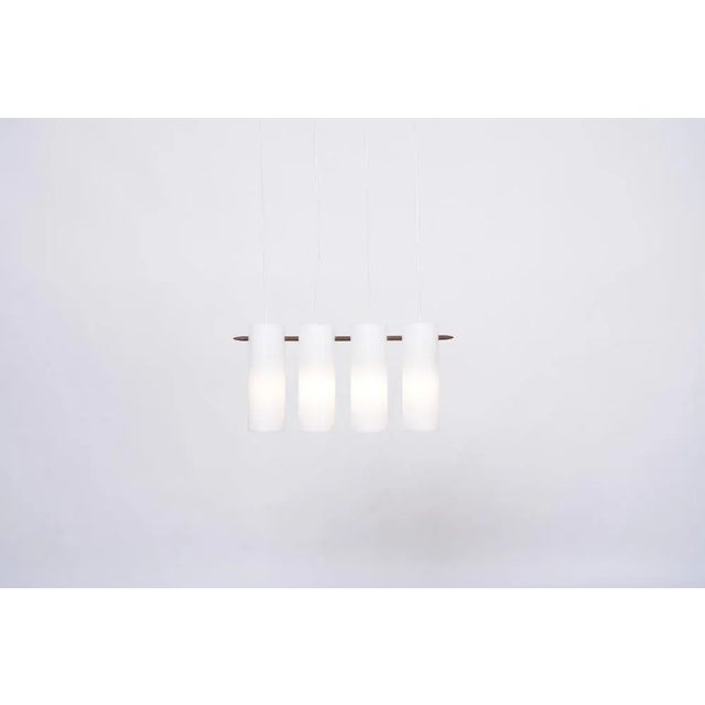 Swedish Mid-Century Modern pendant lamp by Uno and Östen Kristiansson for Luxus. This minimal Mid-Century Modern pendant...