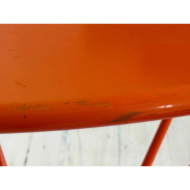 Vintage modern round orange enameled metal center table.