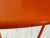 Vintage modern round orange enameled metal center table.