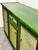 A striking vintage green lacquered sideboard featuring beautifully textured woven cane panels on each door and drawer. The...