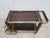 Signature chrome serving trolley with two small and one large tray, made of brown oak. The bar was designed and...