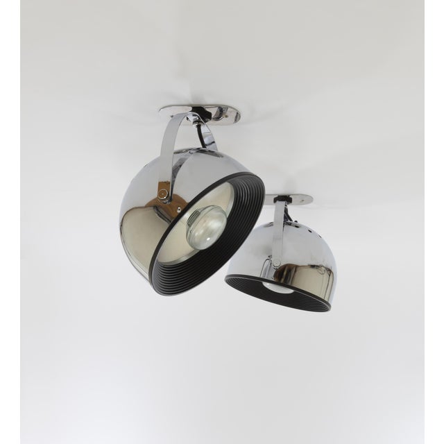Pair of swiveling wall spots in chromed metal with silver coloured reflectors designed by Gae Aulenti and Livio...