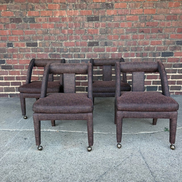 This is a set of four postmodern upholstered dining chairs. They feature a vibrant bronze and black speckled polyester...