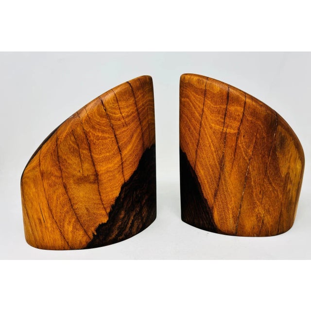 A striking pair of hand-carved solid cocobolo wood bookends designed by Don S. Shoemaker for Señal S.A., Mexico, circa...