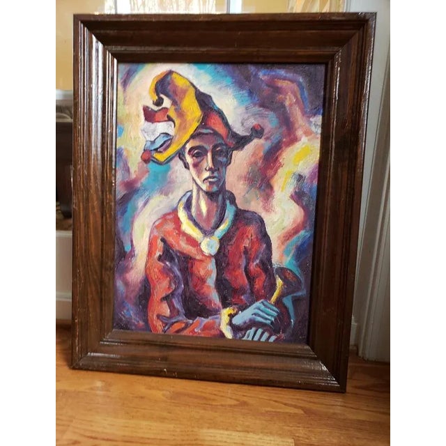 Bold and expressionist in spirit, this mid-20th century original oil painting depicts a jester in vivid strokes of red,...