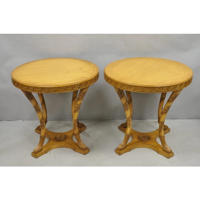 Vintage Italian Regency Round Leather Top Greek Key Carved Side Tables - a Pair. Tables feature tooled leather tops with...