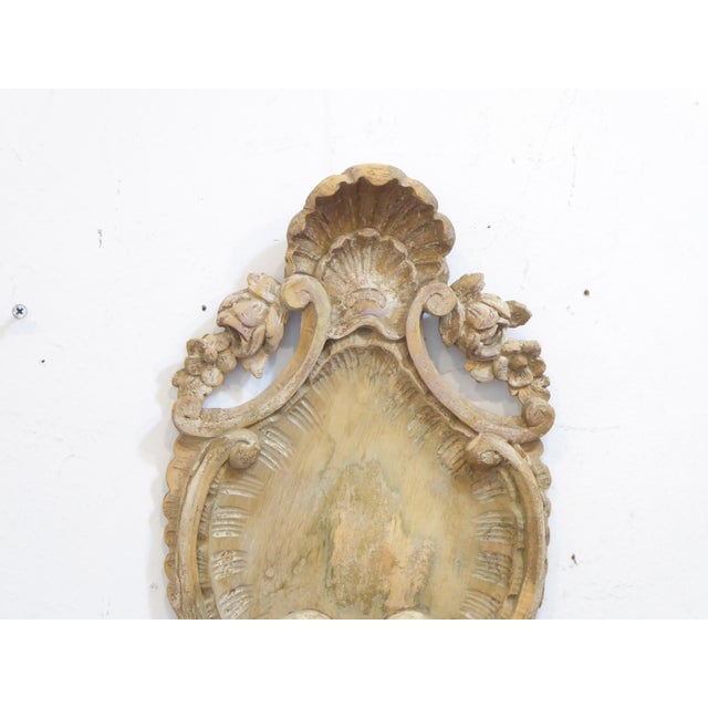 This antique French carved cartouche fragment has a weathered surface.