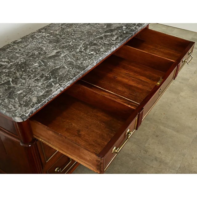 Dimensions: 33 ⅜” H x 49 ½” W x 22 ¾” D A gorgeous Louis XVI style marble-topped mahogany commode from France, circa 1870,...