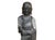 This striking hand-carved dark gray stone statue depicts a Buddhist monk standing in serene contemplation atop a double-...