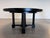A sculptural round dining table by Christian Liaigre, the French designer known for restrained, luxurious modernism, made...