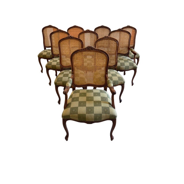 An elegant set of ten vintage Louis XV style dining chairs, showcasing the graceful curves and refined detailing...