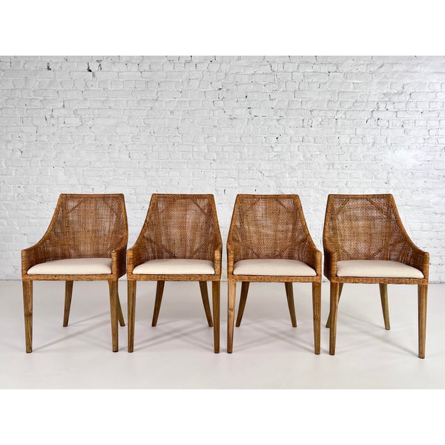 Set of 4 chairs in woven rattan and wood with beige fabric seat.