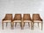 Set of 4 chairs in woven rattan and wood with beige fabric seat.