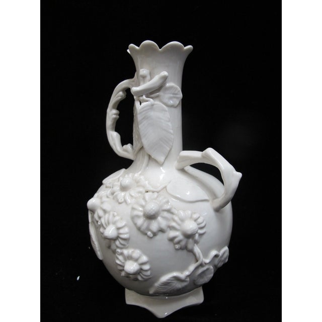 Vintage white porcelain vase, Blanc de Chine in style. Glossy glaze with applied high relief floral and leaf motifs....