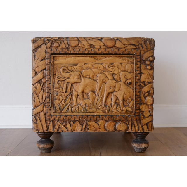 Charming vintage cube-shaped camphor chest with hand carved details depicting African safari scenes with various animals...