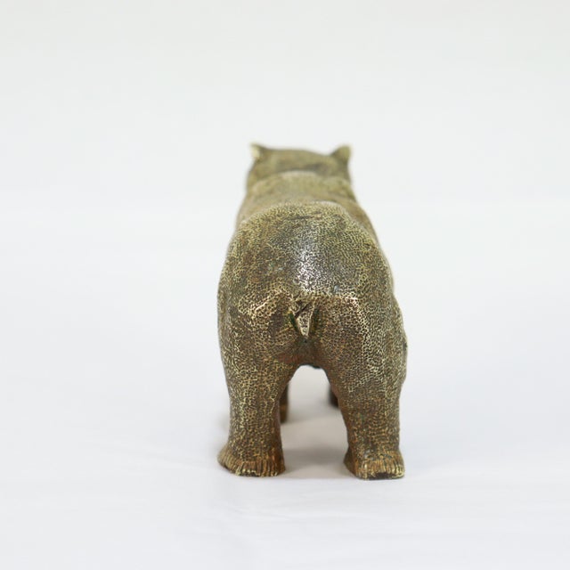A fine, antique cabinet sized sculpture of a bear. In gilt bronze. Modeled naively with the bear standing on all four...