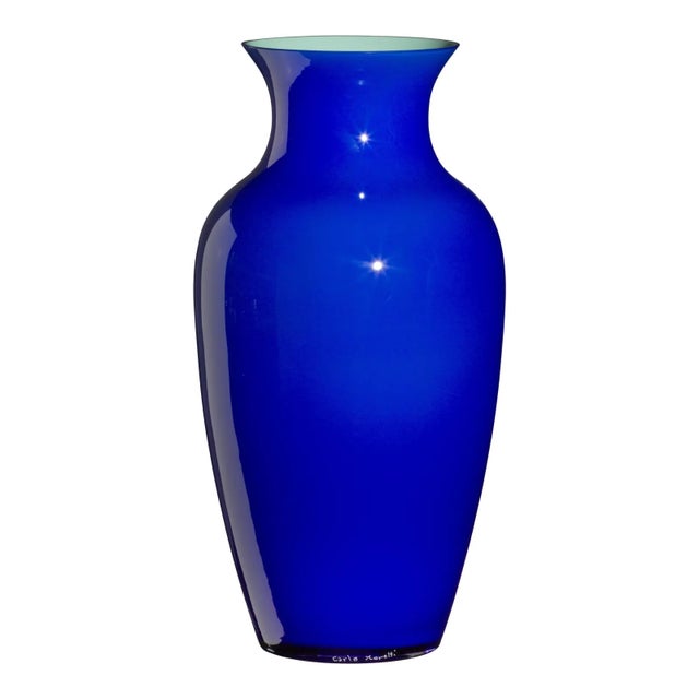 By putting three layers of glass on one another in three distinct moments colored opaque glass, clear crystal and colored...