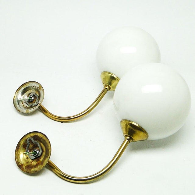 A pair of wall lamps come from the 1950s. They are in good condition. European Plug (up to 250V).The wiring of this item...
