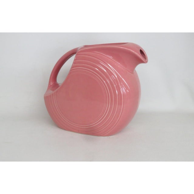 This brilliant Disk Pitcher / Jug is made of ceramic. This beautiful large pitcher is made by Fiestaware, specifically the...