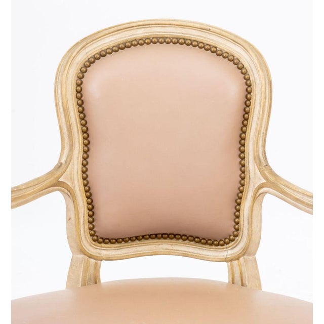 Louis XVI Style White Painted Fauteuil, with pink leather upholstery and wide seat on six cabriole legs. 35.25" H x 33" W...