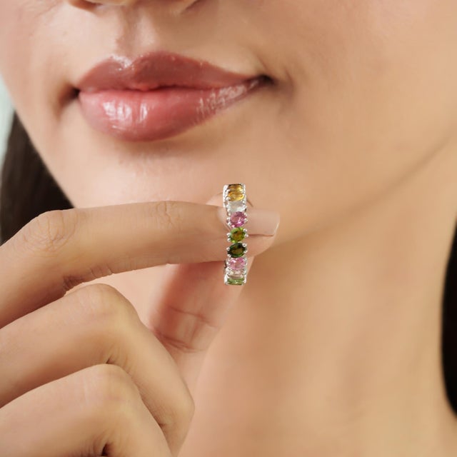 The Boho 3.74 Carat Oval Multi-Color Tourmaline Full Eternity Ring features a continuous row of oval tourmalines in an...