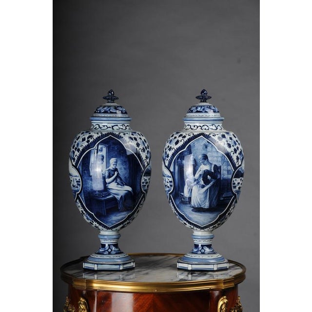 Pair (2) antique Delft lidded vases, 20th Century Ceramic, with the typical Delft blue painting. Bulbous body with...
