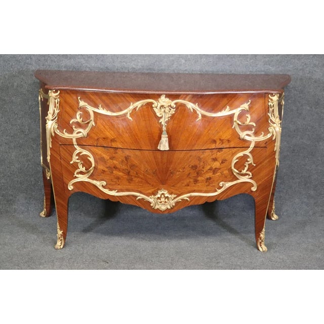 A magnificent 19th-century expression of the Louis XV 'Rococo' aesthetic, this commode is a masterpiece of fine cabinetry...