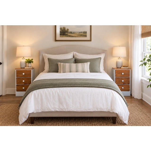 A charming matching pair of vintage handmade solid-wood nightstands featuring compact proportions, warm natural wood...