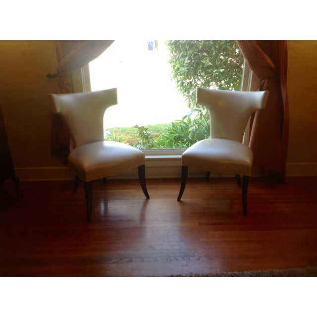 Modern mid century style Klismos dining chairs. Chairs are donenin a faux leather. The chairs are stunning and ready to...