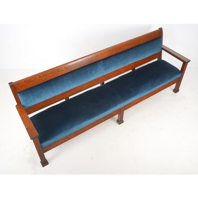 Traditional style settee bench with a dark stained walnut frame and upholstered in a deep blue velvet fabric. Good...