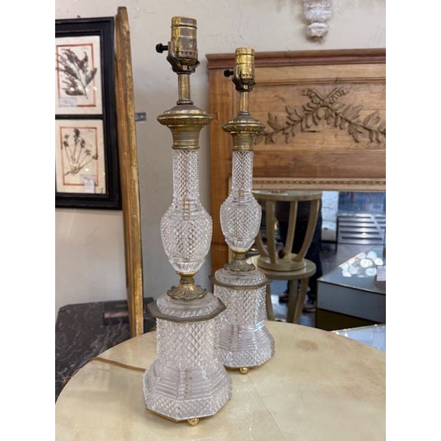 Fine pair of French cut crystal and bronze lamps. French cut crystal lamps are known for their clarity, weight, and...