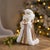Add a touch of elegance to your holiday décor with this Santa Figurines with House in Gold and White (Set of 2). Dressed...