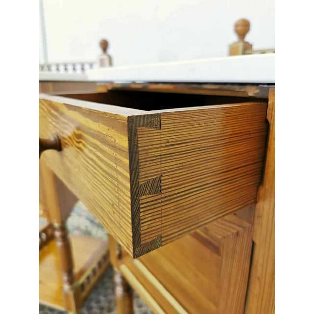 Pair of bedside tables with turned balustrades. The tops are made of marble. Solid wood. Zinc-plated drawer joints....
