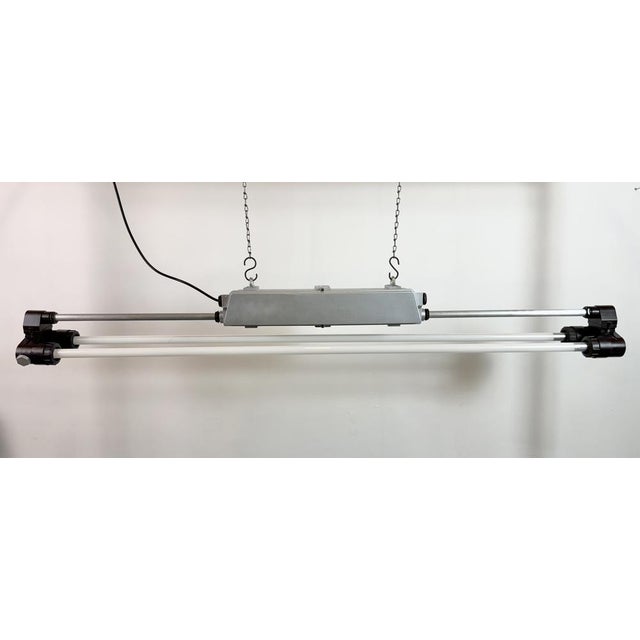 This industrial silver painted cast aluminium and bakelite light was made by elektrosvit during the 1970s in former...