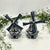 A pair of vintage blue and white ceramic Dutch windmill figurines crafted in the traditional Delft Blue style. They...