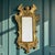 A late 19th century Italian Baroque Revival carved gilt wood wall mirror, circa 1880–1900. The vertically oriented frame...