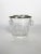 An elegant ice bucket made of clear molded glass, enhanced by a silver-plated metal rim. Dating from the 1970s, this piece...