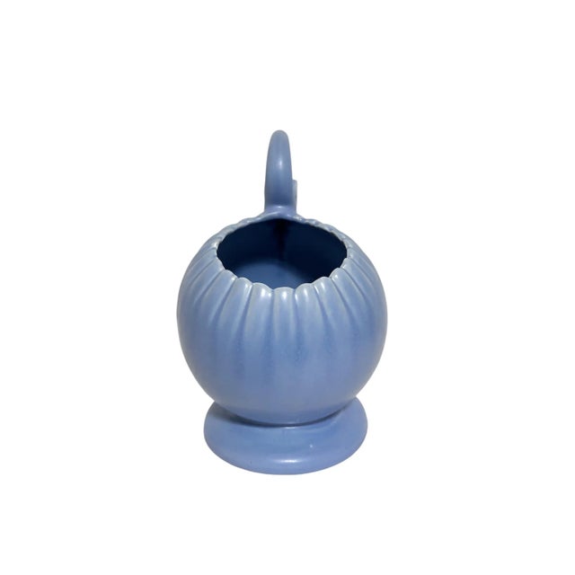 This lovely, unusual single-handled vase was crafted in Camden, Arkansas c. 1950 by the Camark Company. The Camark name is...