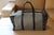 This very nice Goyard bag features the very famous Goyard chevrons woven canvas as well as many pieces of black color...