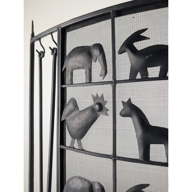 This wrought iron fireplace screen was produced by Atelier Marolles in France during the 1950s. The structure is made...