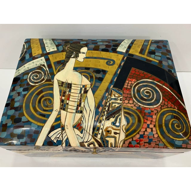 This box is hand painted in an Art Deco style. The interior is lined in black felt The female figure has raised decoration...