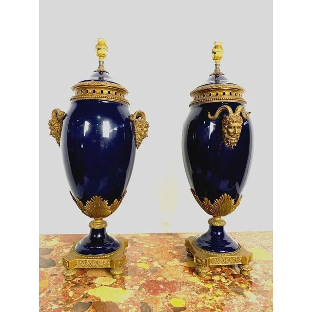 A very elegant pair of french 20th century louis xvi. Cobalt blue sèvres porcelain and ormolu lamps. Each lamp is raised...