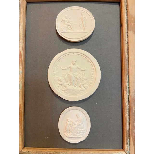 Immerse yourself in the enduring allure of classical antiquity with this truly unique collection of framed intaglios....