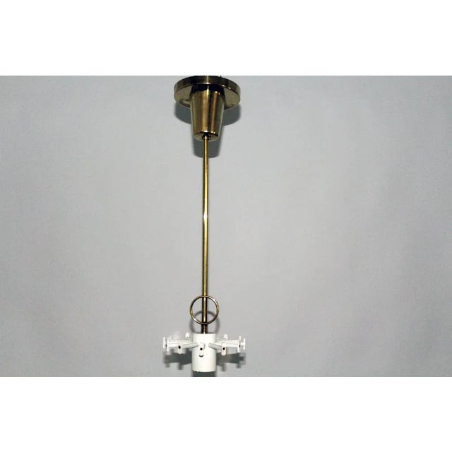 This pendant with 12 cast glass diffusers in a semi-cylindrical shape was produced in Austria by Kalmar. Each glass piece...