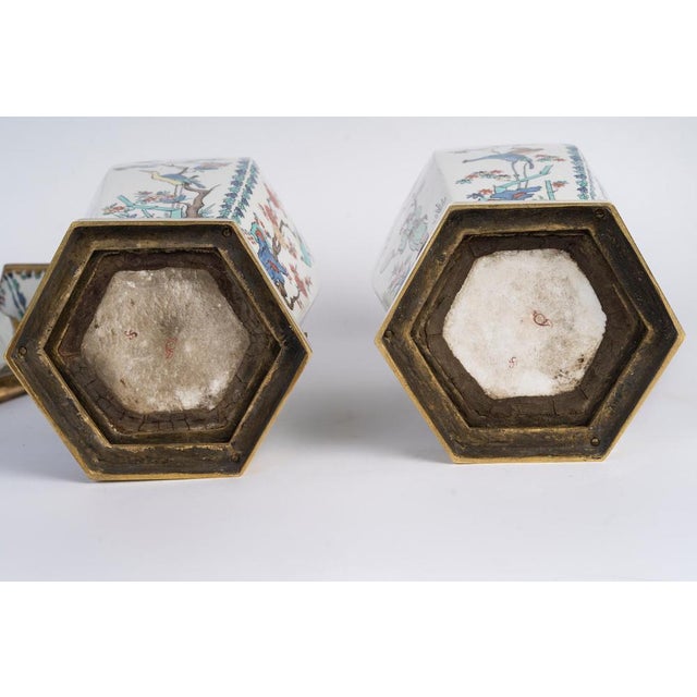 Pair of lidded vases in porcelain and gilded bronze, 20th century. Pair of 20th-century lidded vases in porcelain and...