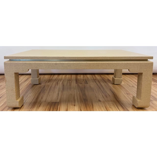 Vintage low profile warm wheat colored grasscloth wrapped Ming leg coffee table with brass accents. Classic Ming leg...